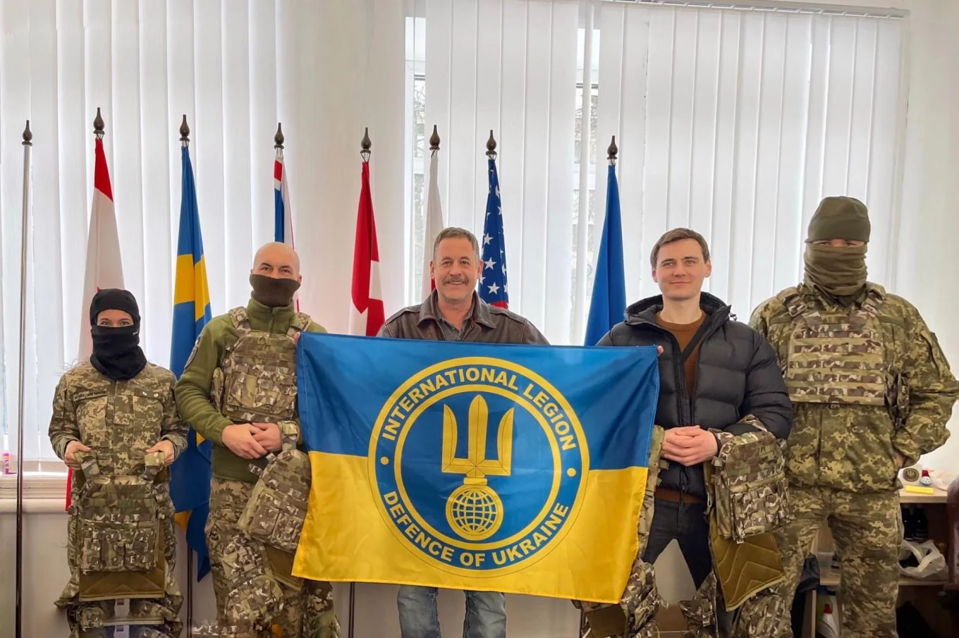 Іноземні добровольці Міжнародного легіону оборони України зі знаменом